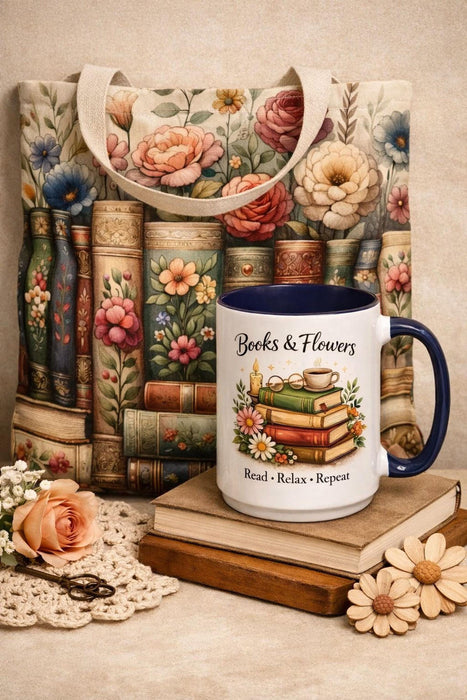 A tote bag with a floral pattern and a mug with a book and flower design, both placed on a stack of books.