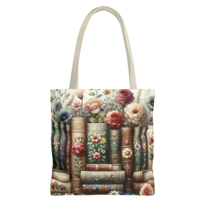 A tote bag with a floral pattern and a mug with a book and flower design, both placed on a stack of books.