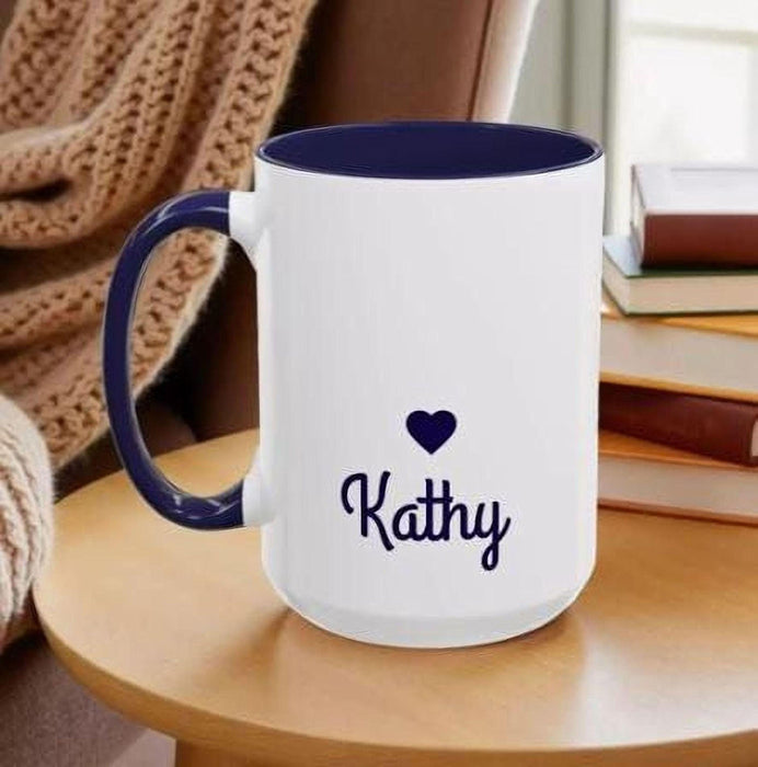 A tote bag with a floral pattern and a mug with a book and flower design, both placed on a stack of books.