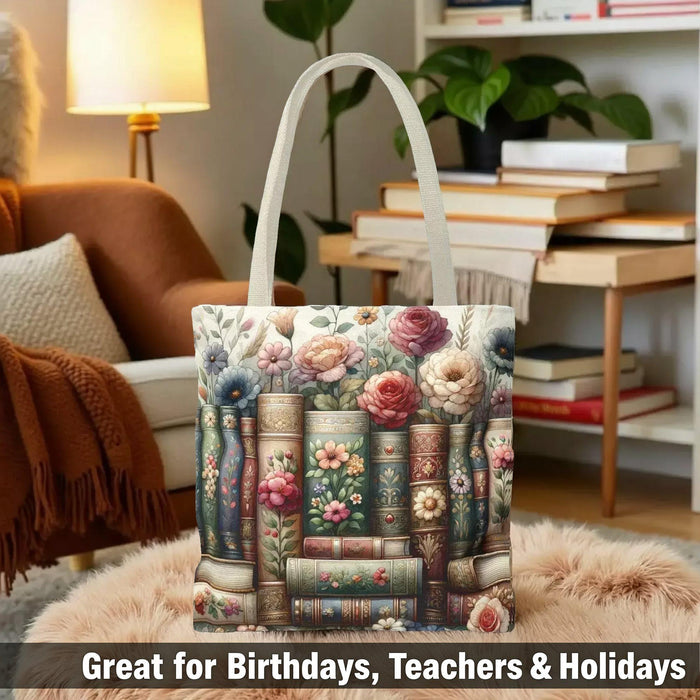 A tote bag with a floral pattern and a mug with a book and flower design, both placed on a stack of books.