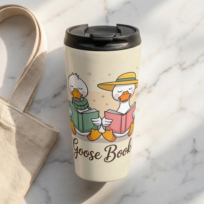 A tote bag and a travel mug with a design featuring cartoon ducks and the text "Silly Goose Book Club" are displayed on a wooden table.