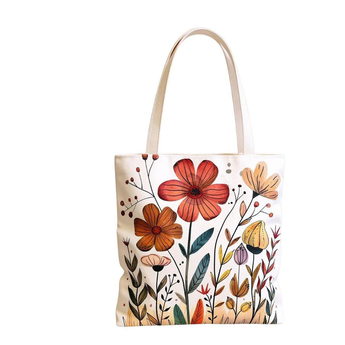 a tote bag with a floral design and a matching mug, placed on a wooden surface.