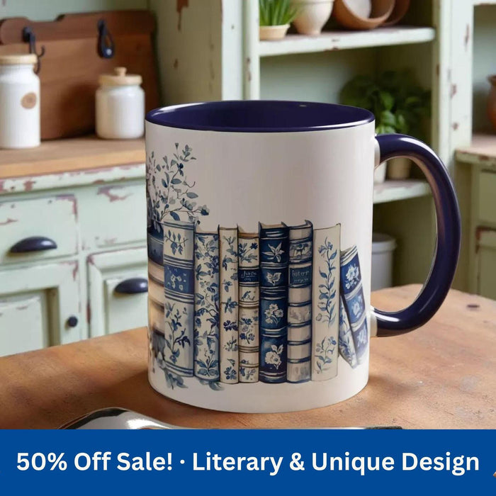 A white tote bag with a blue floral design and a stack of blue and white books, along with a matching blue and white mug, are displayed on a wooden surface.