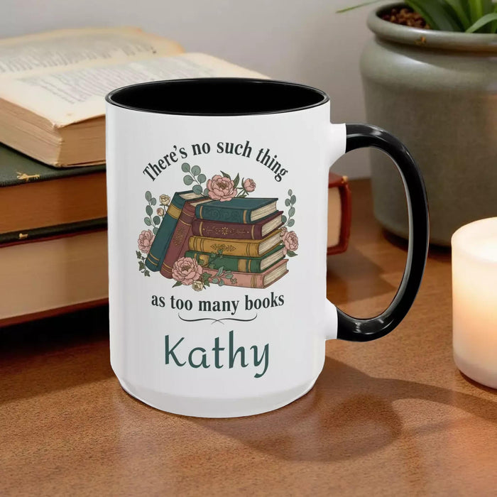 a tote bag and a mug with a printed design, including a stack of books and the text "There's no such thing as too many books" and "There's no such thing as too many books" on them. The items are placed on a table with some greenery, and there is a text overlay that reads "Tote Bag & Mug Gift Set" and "Buy the Tote & add the Mug".