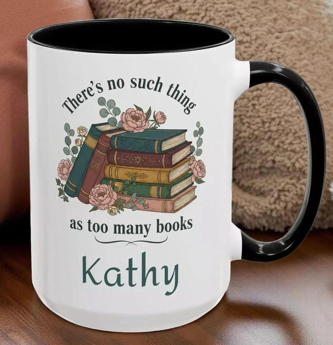 a tote bag and a mug with a printed design, including a stack of books and the text "There's no such thing as too many books" and "There's no such thing as too many books" on them. The items are placed on a table with some greenery, and there is a text overlay that reads "Tote Bag & Mug Gift Set" and "Buy the Tote & add the Mug".