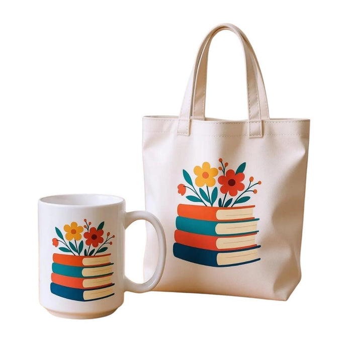 A tote bag with a floral design on it, featuring a stack of colorful books with flowers on top.