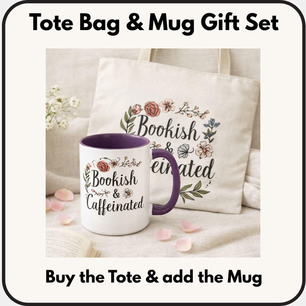 A white tote bag with a floral design and a purple handle, along with a white mug with a floral design and a purple handle, both sitting on a beige surface.