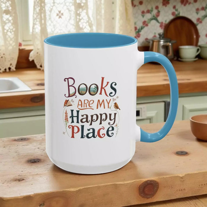 A tote bag and a mug with the text "Books are my Happy Place" printed on them, along with a book and a pen.