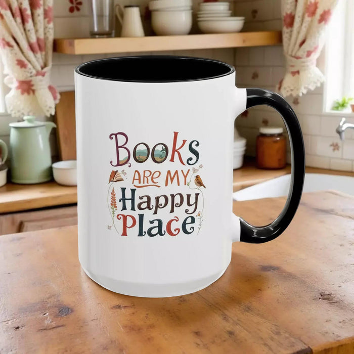 A tote bag and a mug with the text "Books are my Happy Place" printed on them, along with a book and a pen.
