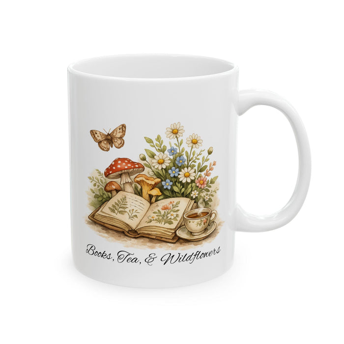 a white tote bag with a floral design, a mug, a book, a pair of glasses, a pair of twine, and some flowers and daisies.